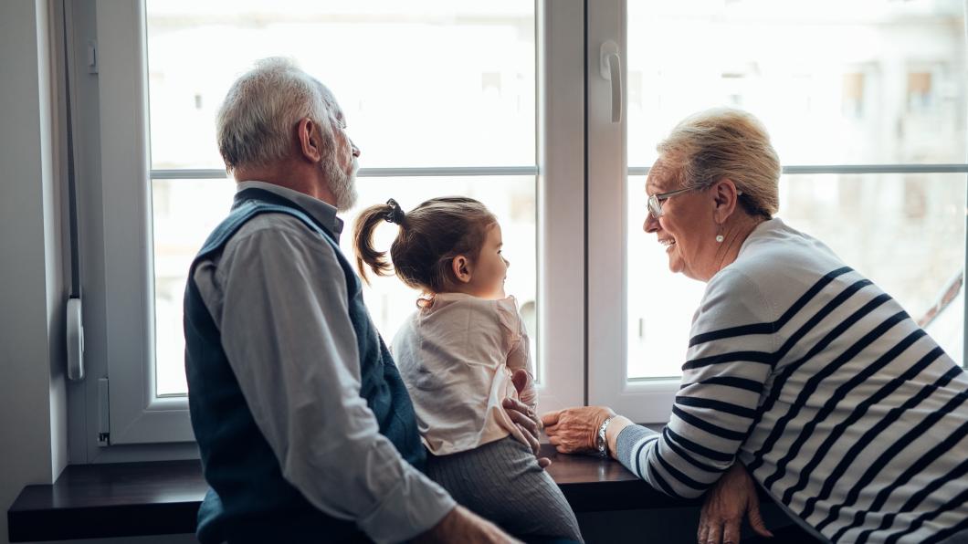 Afbeelding van een familie thuis voor het raam